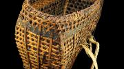An open wickerwork basket made from split bamboo, rattan and rope straps.